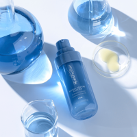 Hydropeptide's Polish and Plump Kit sitting on a pool of water with light orbs sparkling